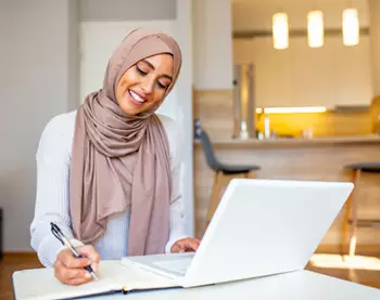 A professional woman works remotely with confidence, representing the flexibility and convenience of a Servcorp virtual office in Saudi Arabia.