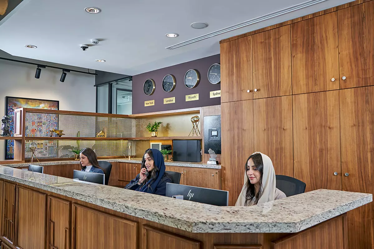 The reception at Servcorp Laysen Valley features a dedicated team providing seamless support in a sophisticated, wood-accented environment.