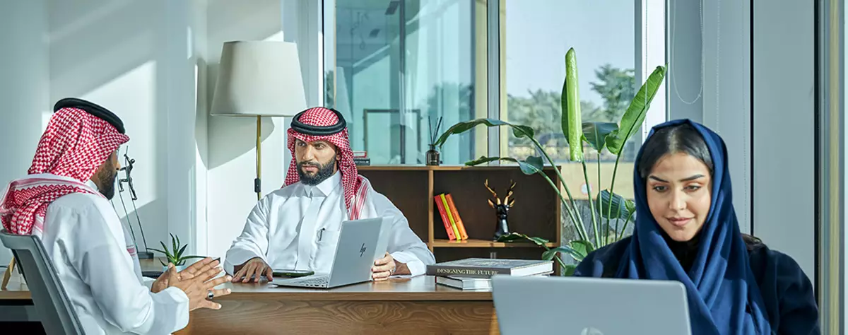 Professionals collaborate in a bright Servcorp serviced office in Saudi Arabia, combining focused workspaces with a modern, executive setting.