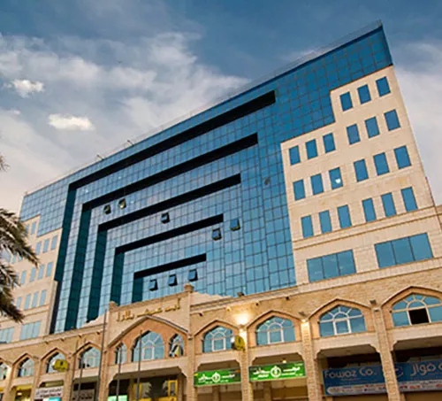Abu Ouf Plaza in Madinah features a distinctive blue-glass façade and traditional architectural elements, offering Servcorp clients a prestigious business presence in the holy city.